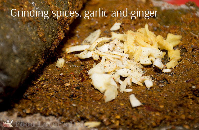 Grinding spices, garlic and ginger on a stone