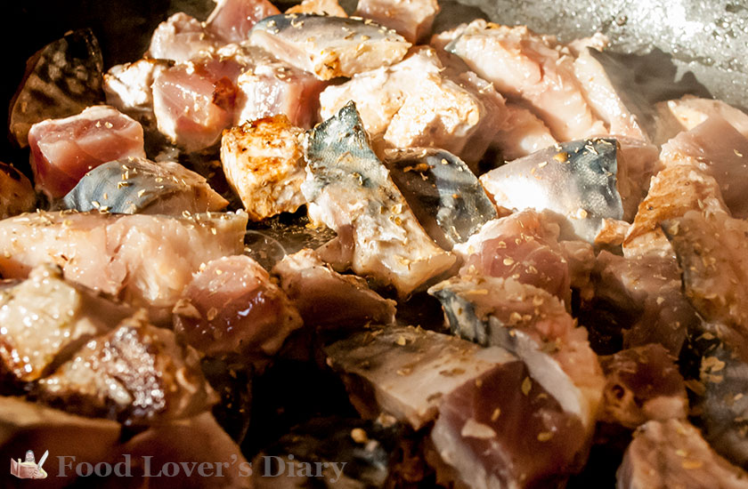 Frying the fish in oil from the tinned anchovies