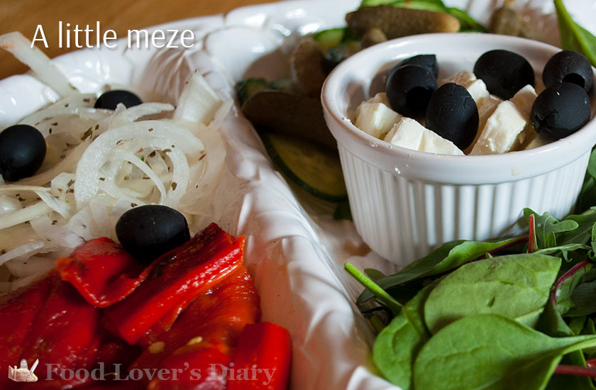 A very basic meze of olives, peppers, onions and salad